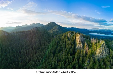 Rocky peak of high mountain with vegetation in valley of Rhodope mountains and forests against background of sky with large clouds. Panorama, top view - Shutterstock ID 2229593607