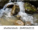 Rocky river with boulders and turbulent flowing water in the Chegem Gorge in the summer in the mountains of the North Caucasus                               