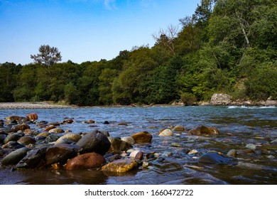 Rocky riverbank and forest on the opposite bank - Shutterstock ID 1660472722