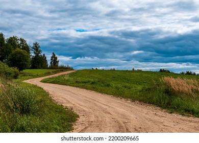 A Rocky Road With A Bend Leads Up A Hill.