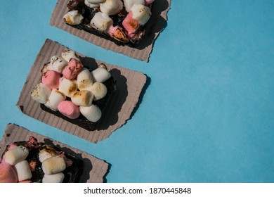 Rocky Road Brownies With Colorful Marshmallows On Blue Background