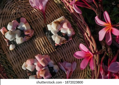 Rocky Road Brownies With Colorful Marshmallows On Wooden Plate With Flowers