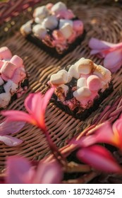 Rocky Road Brownies With Colorful Marshmallows On Wooden Plate With Flowers