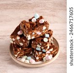 Rocky road with mini marshmallow. No-bake slice made up of milk chocolate, biscuits and marshmallows
