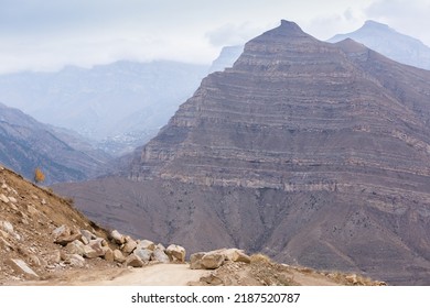 Rocky Road In The Mountains. Blocks Of Stones On The Path. Dirt Road Among The Peaks. Panoramic Landscape View In Dagestan, Russia