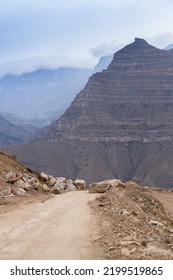 Rocky Road In The Mountains. Blocks Of Stones On The Path. Dirt Road Among The Peaks. Panoramic Landscape View In Dagestan, Russia