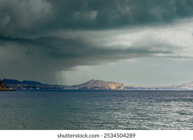 Rocky seashore against the background of rain clouds. - Powered by Shutterstock