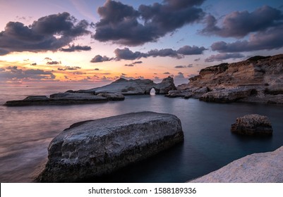 Rocky seashore seascape with wavy ocean and dramatic and beautiful sunset at sea caves coastal area  in Paphos, Cyprus - Powered by Shutterstock