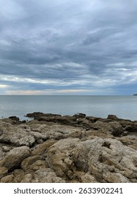 Rocky seashore under dramatic cloudy sky in Mersing , Johor , Malaysia. 