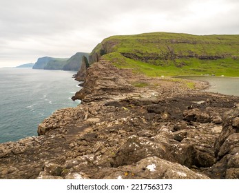 Rocky Shore Above The Bøsdalafossur Waterfall, Which Flows From Lake Sørvágsvatn- Leitisvatn Into The Atlantic Ocean. It Is 30 Meters High. Faroe Islands.