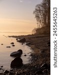 rocky shore of the Baltic sea at dawn haze