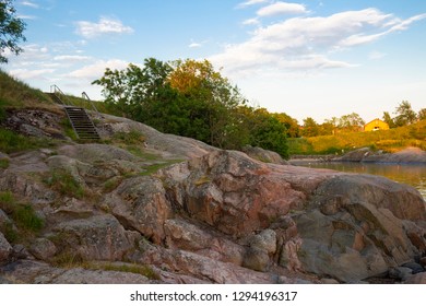 The rocky shore and bay of Suomenlinna Island in the Gulf of Finland is a beautiful traditional landscape of Finland, a summer evening in Finland.