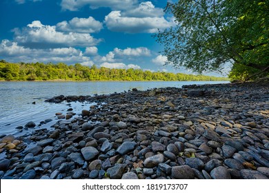 The rocky shore of the Delaware River at Giving Pond boat launch in Tinicum, Pennsylvania, USA.