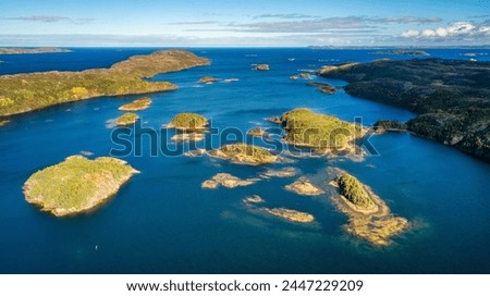Rocky Shore on East Coast of Atlantic Ocean. Aerial Nature Background. Sunny Blue Sky. Newfoundland, Canada.