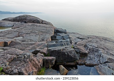 Rocky shore of Superior Lake at sunset - Shutterstock ID 239123056