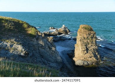 Rocky shore, vegetation and rock in the sea. Village of Rezovo, Burgas, Black Sea, Bulgaria, EU. April 27, 2024. - Powered by Shutterstock