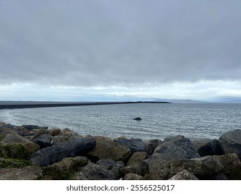 
Rocky shoreline with an overcast sky - Powered by Shutterstock