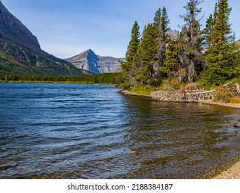 The Rocky Shoreline of Swiftcurrent Lake with Grinnell Point, Glacier National Park, Montana, USA