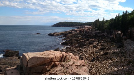 Rocky Tree Lined Shoreline With Waves