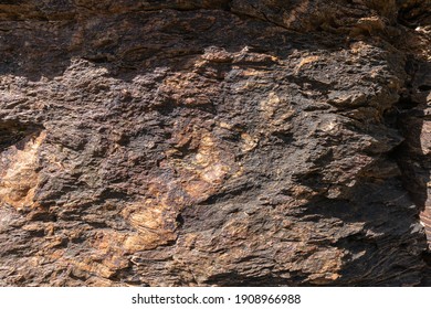 Rocky Uneven Surface, The Rock Is Gray And Brown In Color