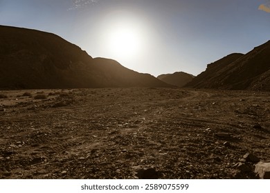Rocky valley in marsa alam desert, egypt, basking under the bright sun, revealing a stunning landscape of barren beauty and rugged terrain