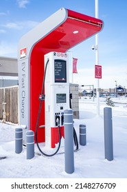 Rocky View County Alberta Canada, April 20 2022: Petro Canada Fast Charge EV Charging Station For Canada's Electric Highway Network After A Snowfall.