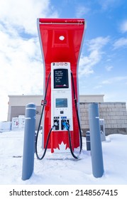 Rocky View County Alberta Canada, April 20 2022: Ice An Snow Covered Petro Canada Fast Charge EV Charging Station For Canada's Electric Highway Network At Cross Iron Mills Shopping Center.