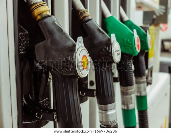 Rodange,\
Luxembourg - December 10 2019 : Jet nozzles or hoses with tap for\
dispensing fuel at a gas station. Rising prices, fuel prices,\
increasing oil price, high price of\
oil.