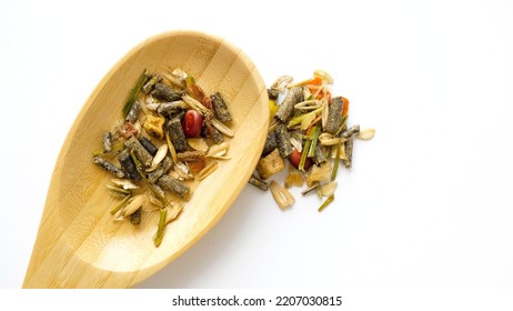 Rodent Food From Cereals And Seeds In Wooden Spoon On A White Background