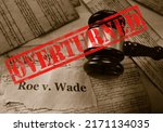  Roe v Wade news headline with gavel and Overturned stamp on a copy of the United States Constitution                              