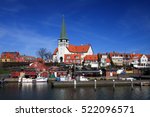 Roenne harbor and church seen from the sea, Bornholm, Denmark.