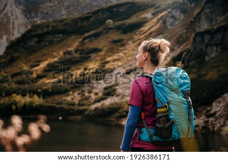 Rohacske lake in Slovakia. Western Tatras mountains, Rohace Slovakia. Woman hiker with backpack rises to the mountains. Discovery travel concept.