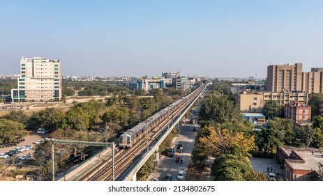 Rohini, India, 2022. Aerial Shot Of Delhi Metro Tracks In Urban Areas Of Delhi NCR, With Metro Running On The Tracks. A Very Useful Addition To Existing DMRC Rail Network