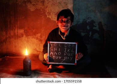 Rohtak, Haryana, India - January 28, 2016: Poor Little Girl Studying At Home With Diya Light, A Small Cup-shaped Oil Lamp Made Of Baked Clay Is Called Diya In Rural India.