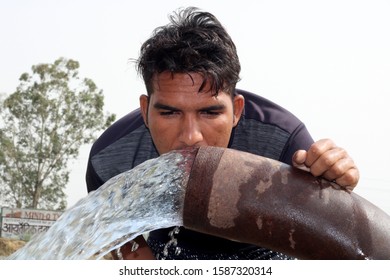 Rohtak, Haryana, India - May 30; 2018: Thirsty men drinking water outdoor in nature.