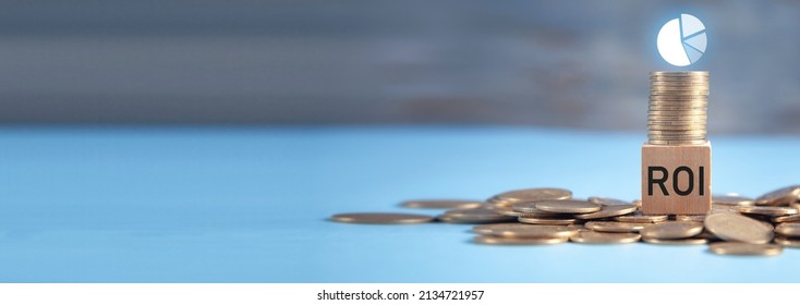 ROI On Wooden Cube With A Coins And Pie Graph.