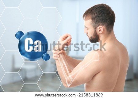 Role of calcium for human. Young man suffering from pain in wrist, digital compositing with illustration of arm bone