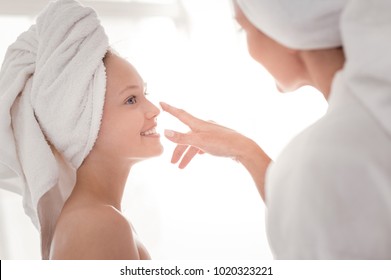 Role Model. Happy Positive Beautiful Girl Looking At Her Mother And Smiling While Enjoying Beauty Procedures With Her