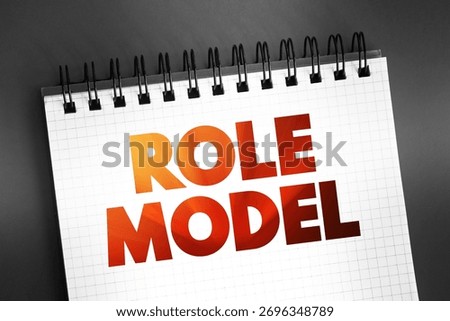 Role Model - person whose behaviour, example, or success is or can be emulated by others, text on notepad, concept background