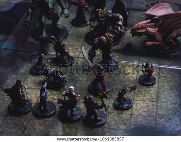Role play board game with miniatures with\
dragon in dungeons.