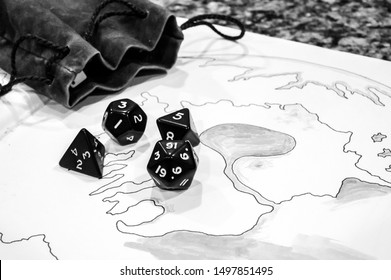 Role playing dice scattered on top of drawing of a map