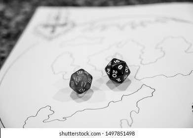 Role Playing Dice Scattered On Top Of Drawing Of A Map