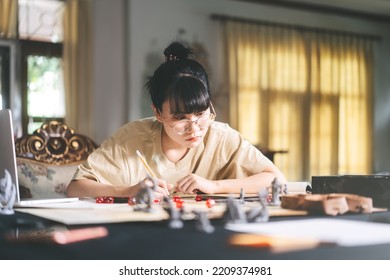 Role Playing Tabletop And Board Game Hobby Concept. Young Adult Asian Woman Enjoying With Storytelling. Blur Foreground With Monster Miniatures And Dice Component.