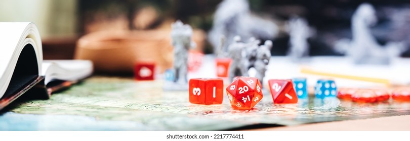 Role Playing Tabletop And Board Game Hobby Concept. D12 Dice Place On Character Sheets For Create Begin Fantasy And Adventure Blur Book And Miniatures. Banner Size Background.