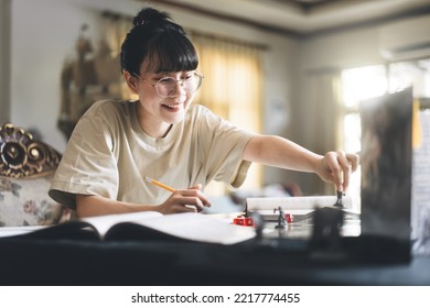 Role Playing Tabletop And Board Game Hobby Concept. Happy Young Adult Asian Woman Enjoying With Storytelling Fantasy Adventure. Blur Foreground With Monster Miniatures And Dice Component.