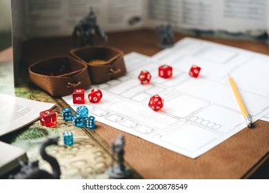 Role Playing Tabletop And Board Games Hobby Concept. D20 Dice Place On Character Sheets For Create Begin Fantasy And Adventure. Background With Book And Miniatures.