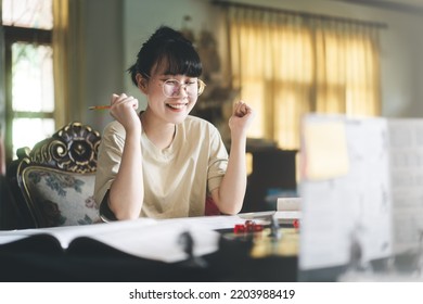 Role Playing Tabletop And Board Games Hobby Concept. Young Adult Asian Woman Enjoying With Storytelling. Blur Foreground With Dungeon Master Screen And Monster Miniatures.