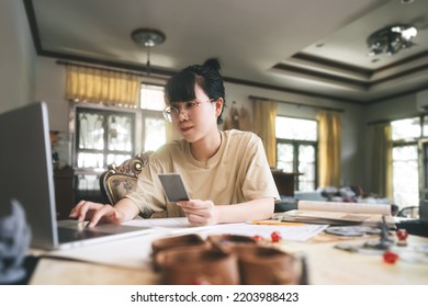 Role Playing Tabletop And Board Games Hobby Concept. Young Adult Asian Woman Using Laptop For Streaming Online With Friends. On Table With Blur Dice And Miniatures.