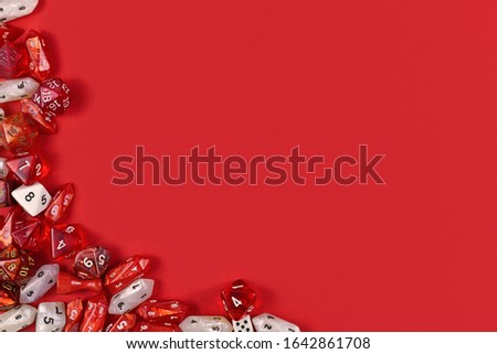 Roleplaying background with RPG dice at side of red background with blank copy space