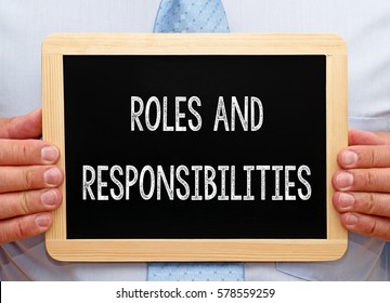 Roles and Responsibilities - Businessman holding chalkboard with text